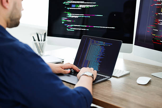 istock Programmer working with laptop at desk in office, closeup 2242095987