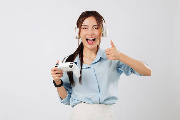 istock Game session with happy Asian young woman holding controller mid video game 2242098893
