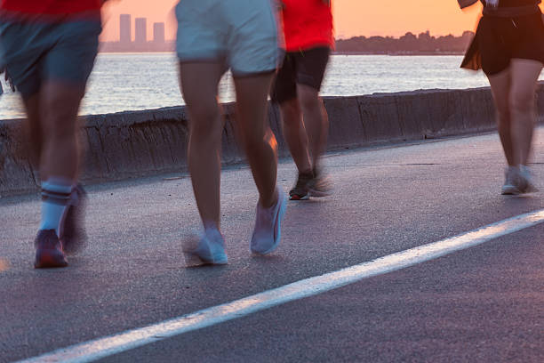 Running, adventure and back of people by beach on tropical vacation, holiday or getaway together. Fun, travel and group of friends by ocean with activity, journey or freedom on seaside weekend trip.