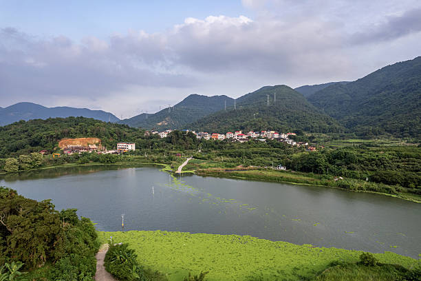 Fields and rural houses by the mountain and river