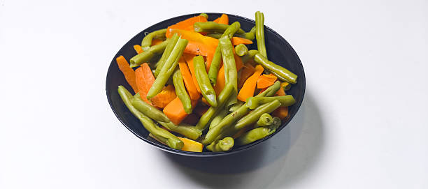 Stir-fried green beans and carrots on a plate isolated on a white background, good for recipe, article, menu book, or any cooking contents.