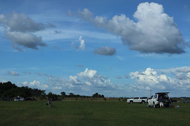 istock An open grassy field under a partly cloudy sky 2242108411
