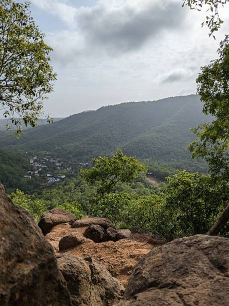 istock Mountain Valley Hamlet Framed by Rocks and Lush Green Foliage 2242108833