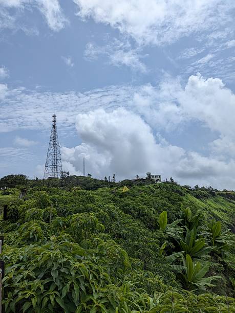 istock Distant view of Sinhagad Fort and communication tower on lush cliff 2242111393