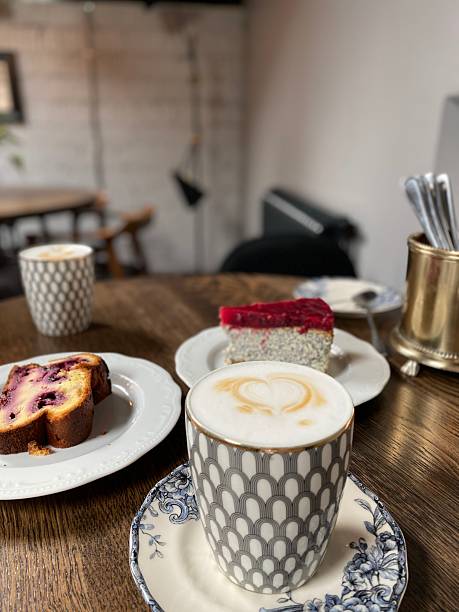 istock Coffee and cake on wooden table in cozy cafe setting with decorative tableware 2242114284