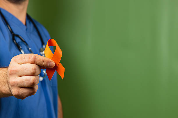 istock Medical professional holds an orange ribbon symbolizing awareness and support 2242117295