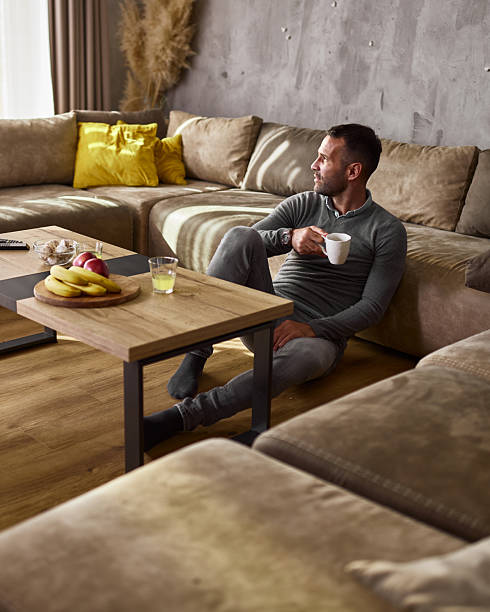 istock Relaxed man day dreaming during coffee time at home. 2242118359