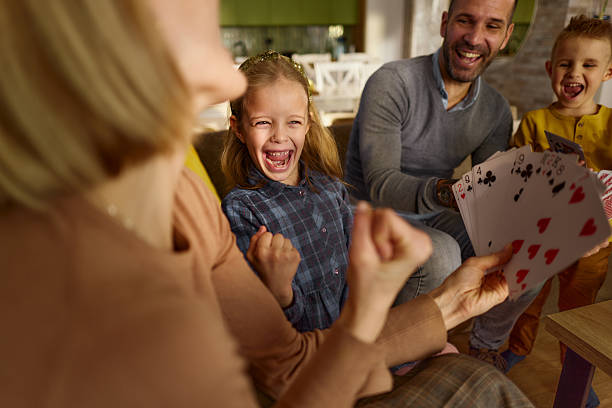 istock Yes mommy, we have the winning cards! 2242118562