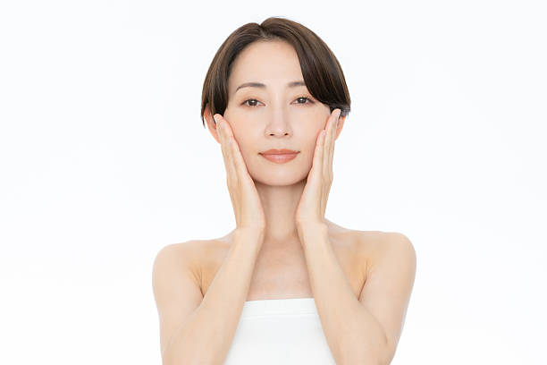 istock Middle-aged woman doing skin care on white background 2242118633