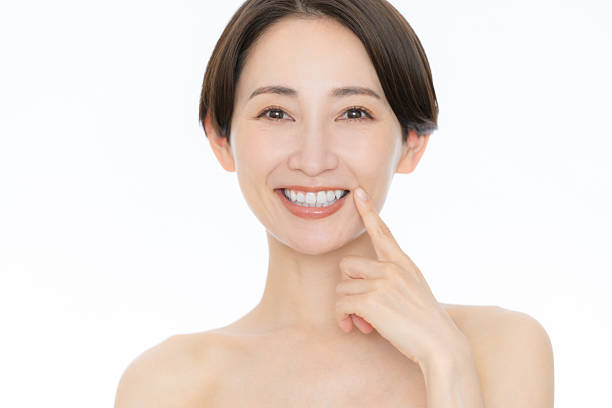 istock Middle-aged woman doing skin care on white background 2242118636