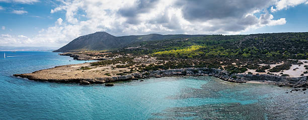 Cyprus Island Aerial Drone View of the Rocky Coastline of the Akamas Pensinsula close to Latchi  - Latsi and the Blue Lagoon, showcasing the vibrant turquoise waters of the Mediterranean Sea. Latchi - Latsi, Akamas National Forest Park, North-Western Coast of Greek Part of Cyprus, Paphos District, Cyprus Island, Mediterranean Island.