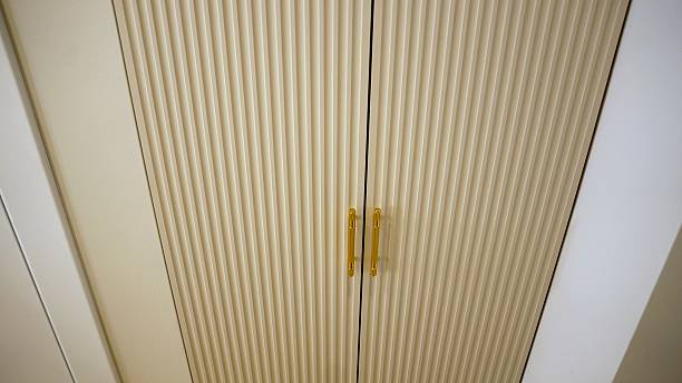 istock Modern beige cabinet with gold handles 2242121864