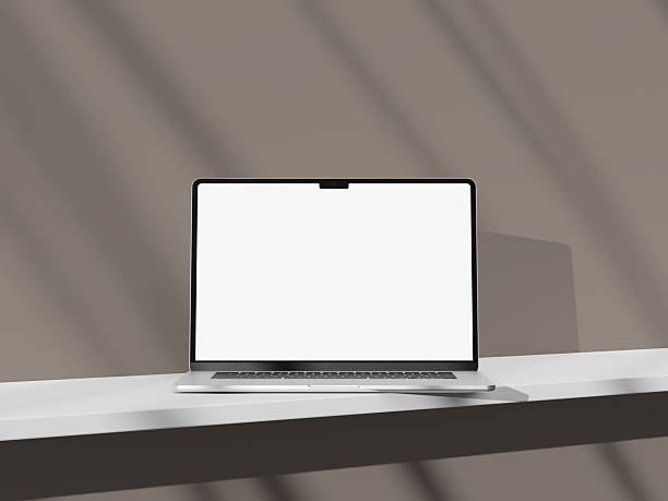 istock Stylish silver laptop on a light-colored desk with an empty screen display. 2242122806