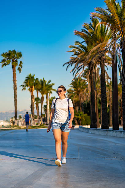 istock Mature woman walking on seaside boulevard - Costa Dorada Spain 2242123164