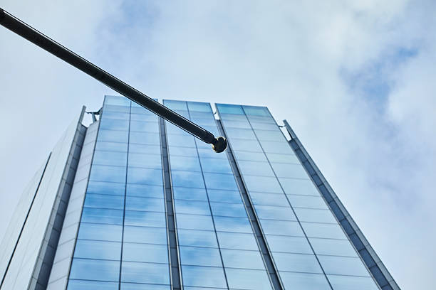 Close up image of a skyscraper facade made with glass windows, modern architecture and concrete blocks