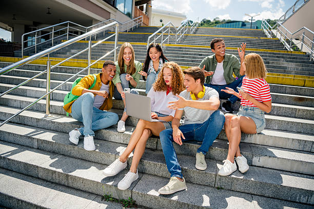 istock Buddies sitting outdoors on steps bonding and enjoying teamwork during a bright summer day 2242125178
