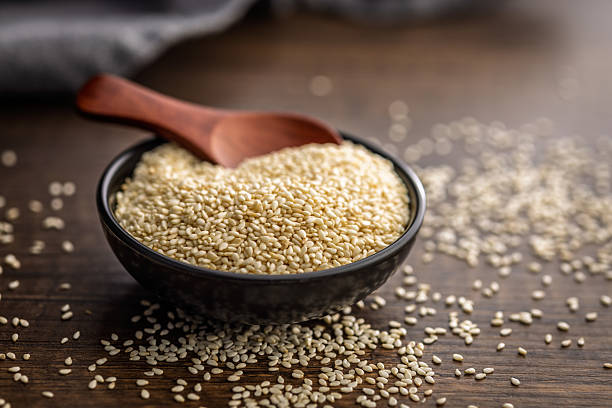 istock Roasted sesame seeds in bowl on wooden table. 2242126484
