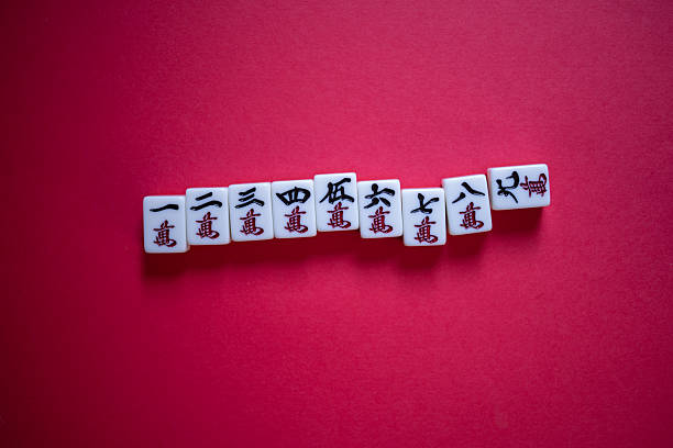 Mahjong tiles lined up on a red background