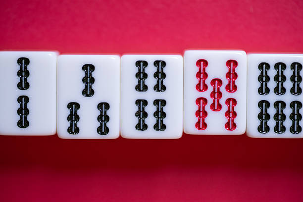 Mahjong tiles lined up on a red background