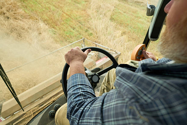 istock Senior Caucasian Man Operating Combine Harvester during Wheat Harvesting 2242126919