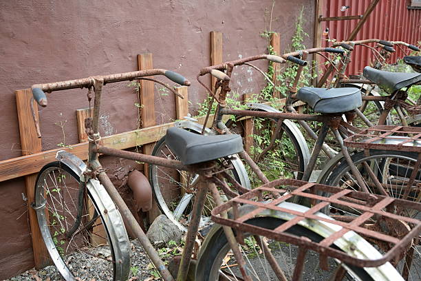 istock Rusty old bicycles leaning against red brick wall outdoors 2242128056