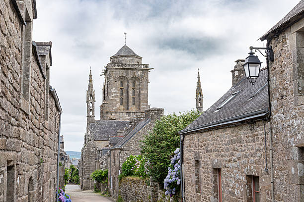 istock Charming stone house with hydrangea garden along cobblestone path in the quaint historic village of Locronan in Brittany, France. 2242128125