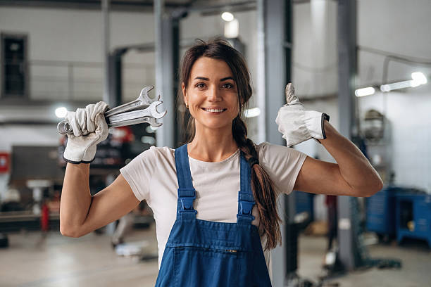 Candid portrait of female mechanic in auto repair shop