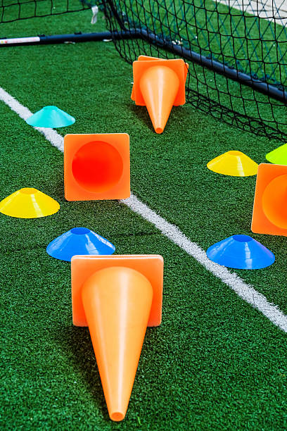 istock Soccer goal and cones on green artificial turf 2242135570