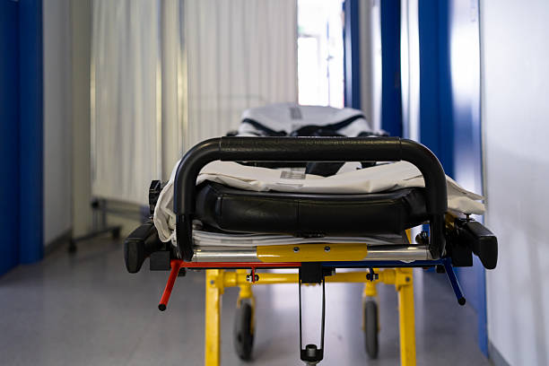Paramedic preparing stretcher for patient. Ambulance car of emergency medical service in city. Themes rescue, urgency and health care.