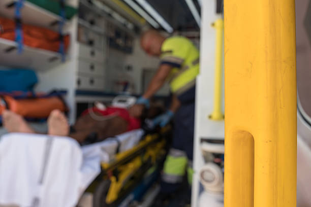 istock Paramedic assisting patient lying on stretcher in ambulance 2242138197