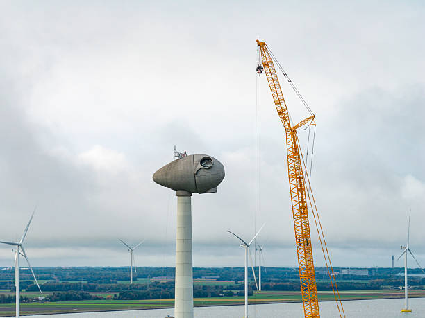 Wind turbine construction with huge cranes at a wind farm in Flevoland, Netherlands.