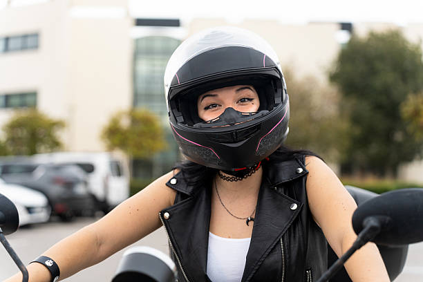 istock Woman biker wearing helmet smiling on motorcycle 2242140996