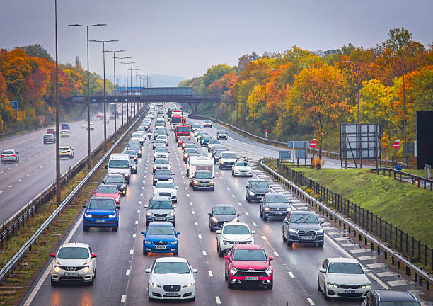 Leicester, UK. 19 October 2025. Heavy traffic on the M1 motorway with rain and autumn leaves.