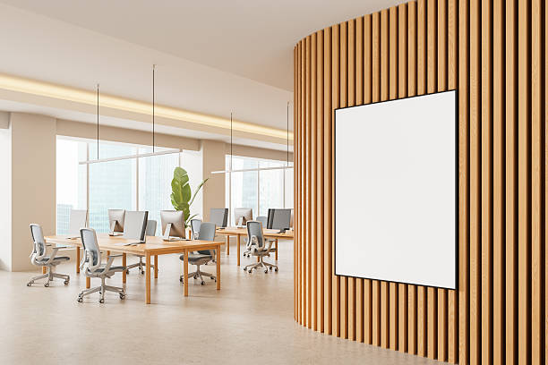 istock Modern office interior with vertical wood slat wall and blank poster mockup in open workspace with desks and computers near large windows during daytime. 3D Rendering 2242142668