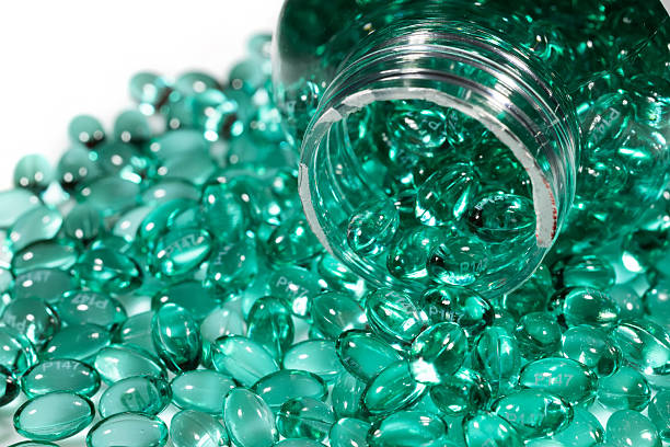 istock Blue capsules in the shell with liquid vitamin. Blue capsules with a dietary supplement for joints teeth and bones 2242142956