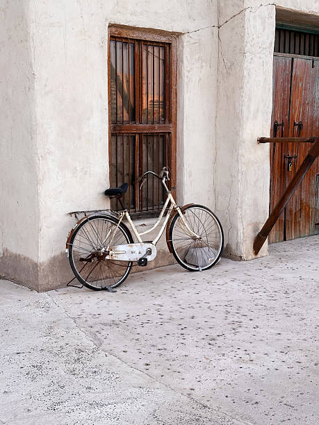 istock Vintage Bicycle Beside Rustic Wall. Old Heritage Street Scene 2242143048