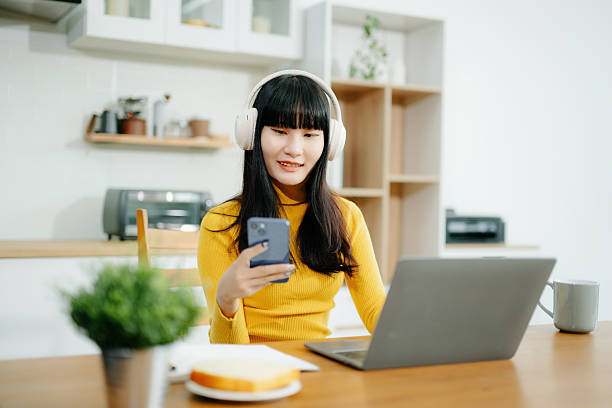 istock Woman using laptop checking email news online sitting on sofa,  working on computer, writing blog 2242144231