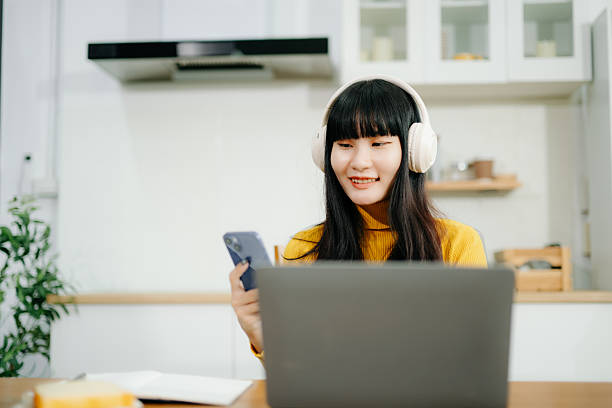 istock Woman using laptop checking email news online sitting on sofa,  working on computer, writing blog 2242144233