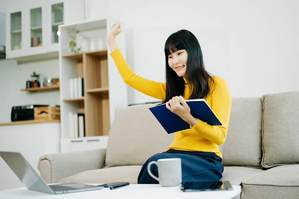 istock Young woman relaxing on couch using smartphone and smiling while browsing onlineuse cellphone 2242144259