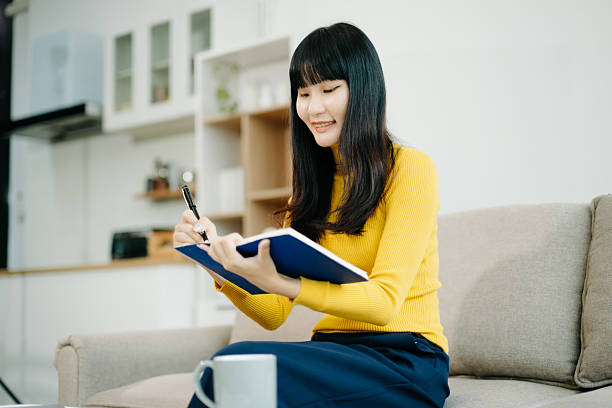 istock Young woman relaxing on couch using smartphone and smiling while browsing onlineuse cellphone 2242144267