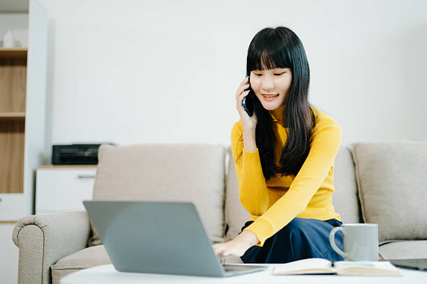istock Young woman relaxing on couch using smartphone and smiling while browsing onlineuse cellphone 2242144268