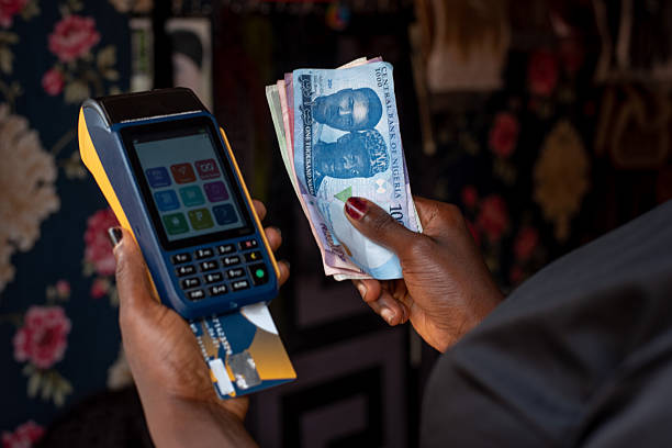istock POS Machine and Nigerian Naira Notes in Hand 2242144455