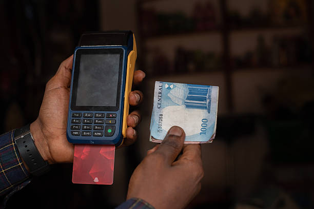 istock POS Machine and Nigerian Naira Notes in Hand 2242144561