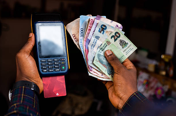istock POS Machine and Nigerian Naira Notes in Hand 2242144578
