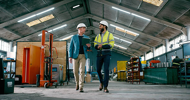 istock Manufacturing, walking or people in warehouse with tablet, team and online check for material. Inspection, partner or director in depot with tech, production or safety management in digital checklist 2242145702