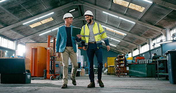 istock Engineering, men or walk with tablet in warehouse for operational efficiency, MRP planning or chat. Operations manager, happy engineer and tech in manufacturing plant for quality control and teamwork 2242145703