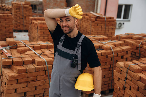 istock Smiling, positive facial expression. A builder is working at the construction site at daytime 2242146821