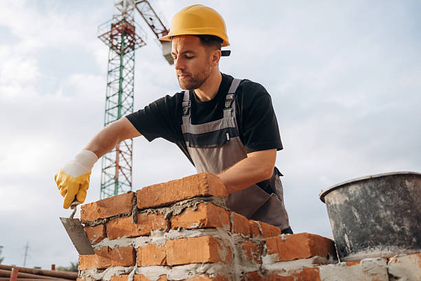 istock Bunch of bricks, busy. A builder is working at the construction site at daytime 2242147602