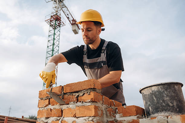 istock Bunch of bricks, busy. A builder is working at the construction site at daytime 2242147613