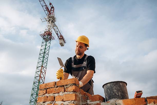 istock Busy, against the crane in distance. A builder is working at the construction site at daytime 2242147647